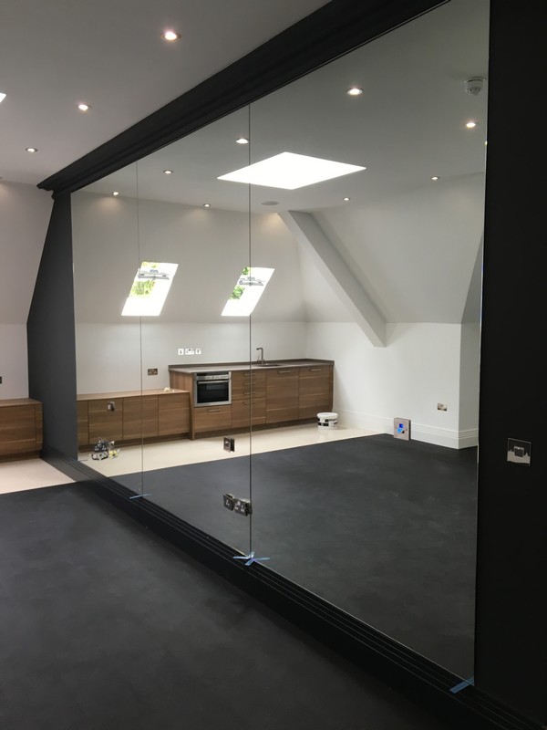 Frameless glass partition in loft conversion by Clapham glaziers