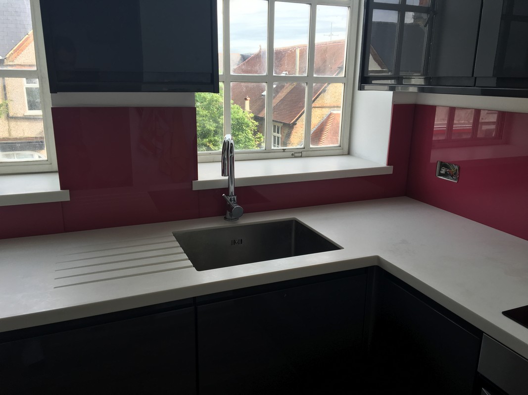 Deep plum coloured glass splashback in modern Clapham kitchen