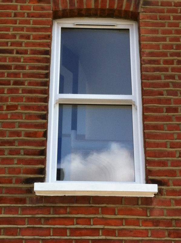uPVC sash window on Victorian red brick house in Clapham